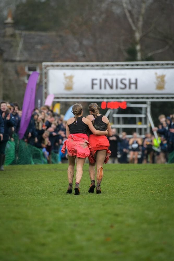 Sedbergh student helping a fellow runner across the finish line