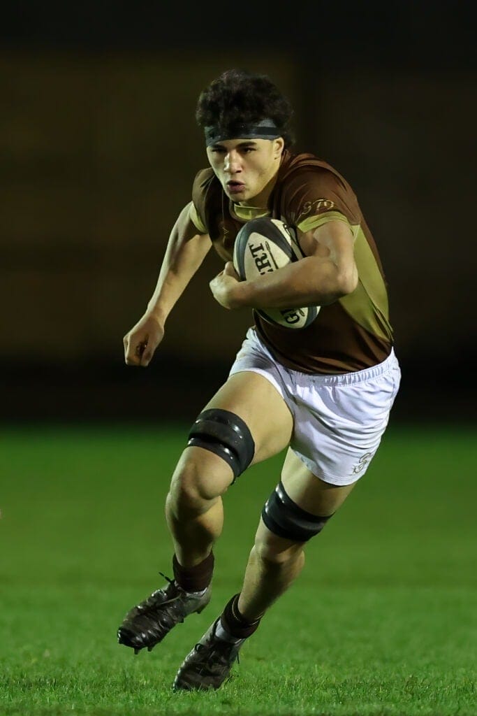 Upper Sixth pupil, Kane, in action against Wellington College in November